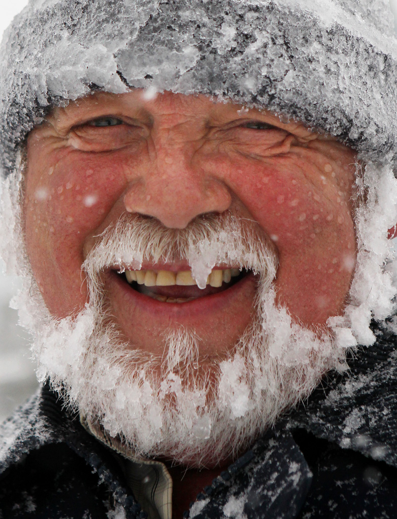 Bob Burnett was out for the third time shoveling out his driveway on Duke Street. He was still able to keep a smile on his face through it all. Photo: Cindy Wilson/Telegraph-Journal